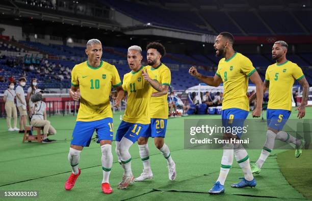 Richarlison of Team Brazil celebrates with Antony and team mates after scoring their side's first goal during the Men's First Round Group D match...