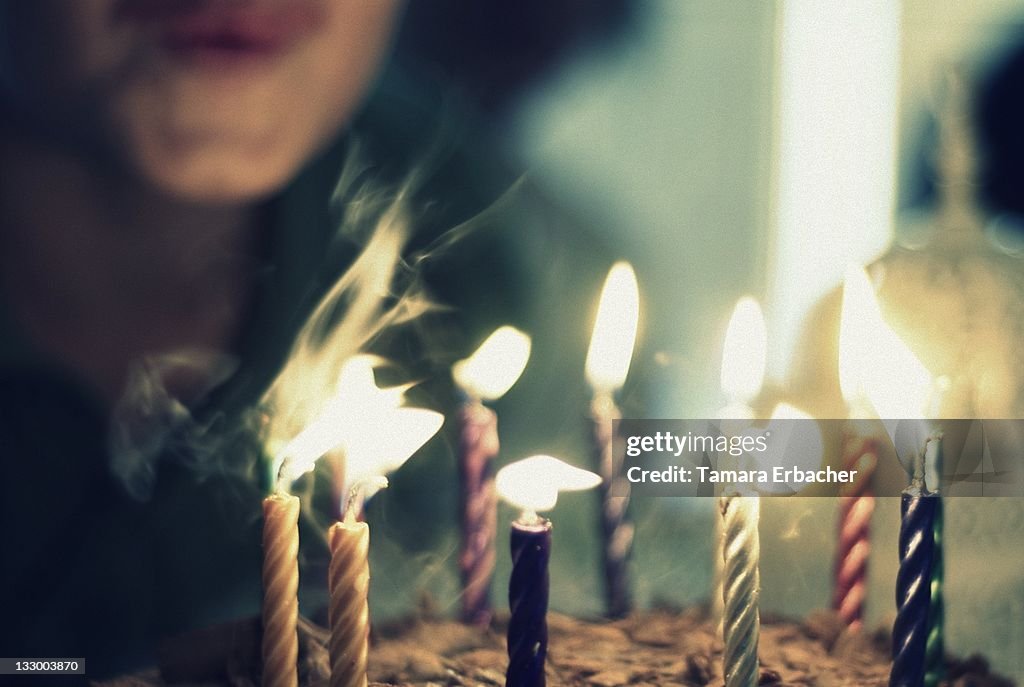 Boy blowing candles