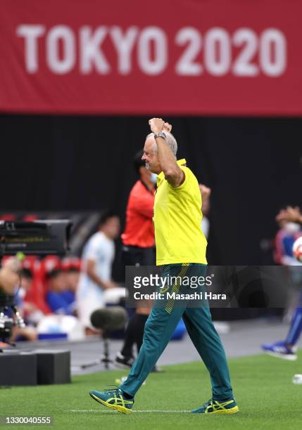 Graham Arnold, Head Coach of Team Australia celebrates after victory in the Men's First Round Group C match between Argentina and Australia during...