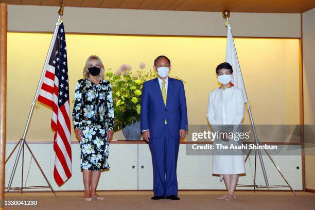 First lady Jill Biden wearing a face mask poses with Japanese Prime Minister Yoshihide Suga and his wife Mariko during their meeting ahead of the...