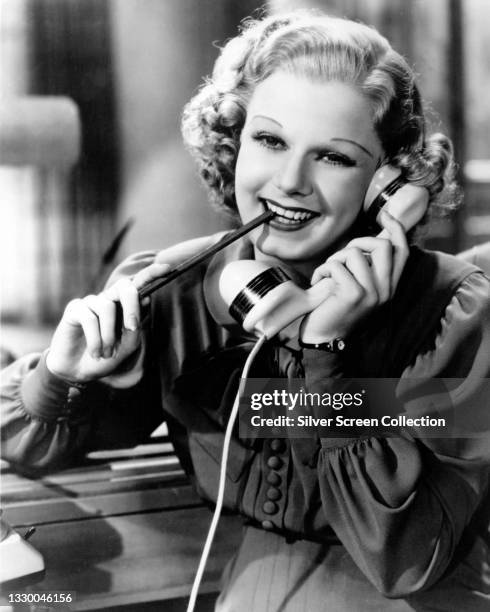 Actress Jean Harlow talks on the phone in a scene of an unspecified film, circa 1930.