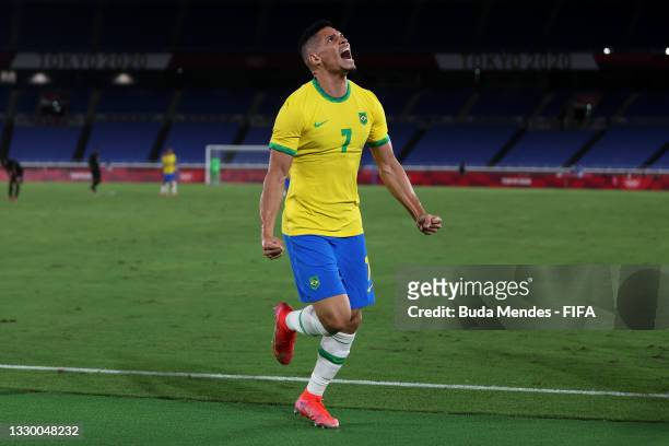 Paulinho of Team Brazil celebrates after scoring their side's fourth goal during the Men's First Round Group D match between Brazil and Germany...