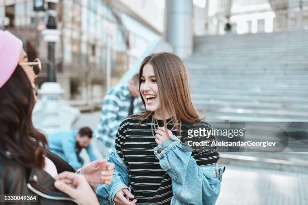 two smiling females enjoying their friendship outside with male friends - massage funny stock pictures, royalty-free photos & images
