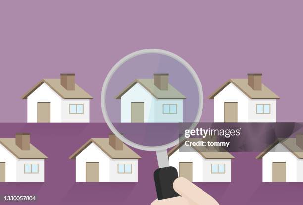 hand holding a magnifying glass to find a new house - housing development stock illustrations