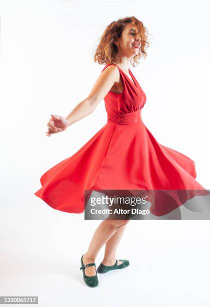 happy woman with red dress dancing and enjoying life. - dress isolated stock pictures, royalty-free photos & images