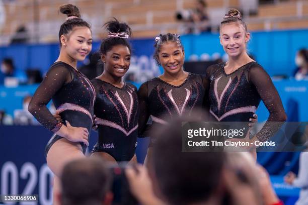 Simone Biles of the United States posing for photographs with team mates Sunisa Lee, Jordan Chiles and Grace McCallum after the Artistic Gymnastics...