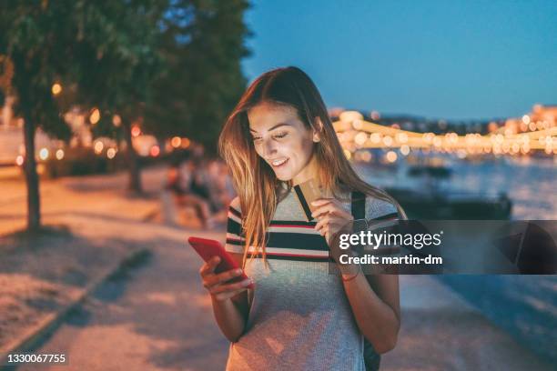 student in budapest using electronic banking on phone - hungary hotel stock pictures, royalty-free photos & images