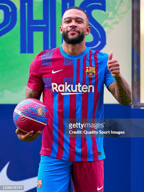 Memphis Depay poses for a photograph during his unveiling at Camp Nou on July 22, 2021 in Barcelona, Spain.