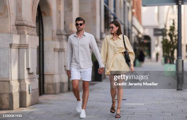 Marie Danker wearing black Zara heels, yellow H&M set, Carolina Lemke shades and black Weat bag and Eric Schulz wearing white Copenhagen sneakers,...