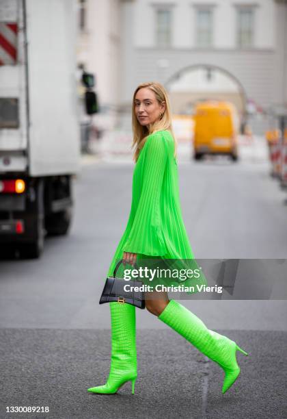 Sonia Lyson is seen wearing green boots Emili Sindlev x Bettina Vermillon, black Balenciaga bag, green dress Essentiel Antwerp on July 21, 2021 in...