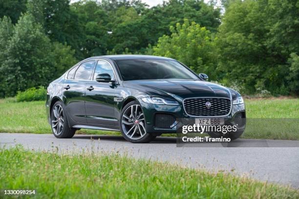 jaguar xf on a road - jaguar car stock pictures, royalty-free photos & images