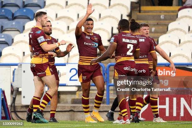 Jermaine McGillvary of Huddersfield Giants celebrates with team mate Will Pryce after scoring his team's fourth try during the Betfred Super League...