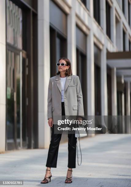 Marie Danker wearing black Zara heels, white H&M top, black House of Dagmar leather pants, white Agneel leather bag, white and back Carolina Lemke...