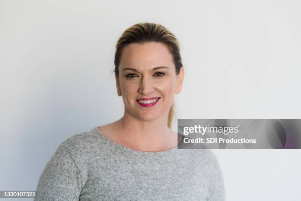 portrait of attractive mid adult female business professional - woman businesswear stock pictures, royalty-free photos & images