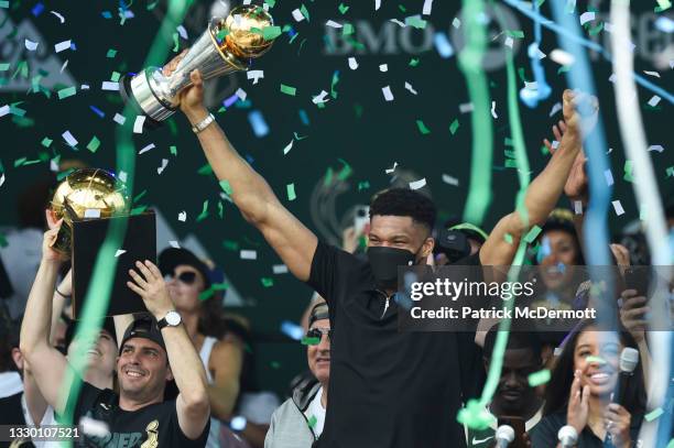 Giannis Antetokounmpo celebrates with the Larry O'Brien trophy during the Milwaukee Bucks 2021 NBA Championship Victory Parade and Rally in the Deer...