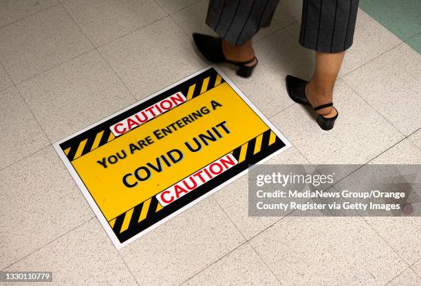 Caution sign is placed on the floor outside the COVID ICU at St. Joseph Hospital in Orange, CA on Wednesday, July 21, 2021. COVID-19 cases have risen...