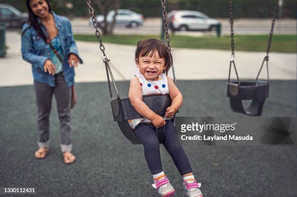 toddler laughing on swing - baby swing stock pictures, royalty-free photos & images