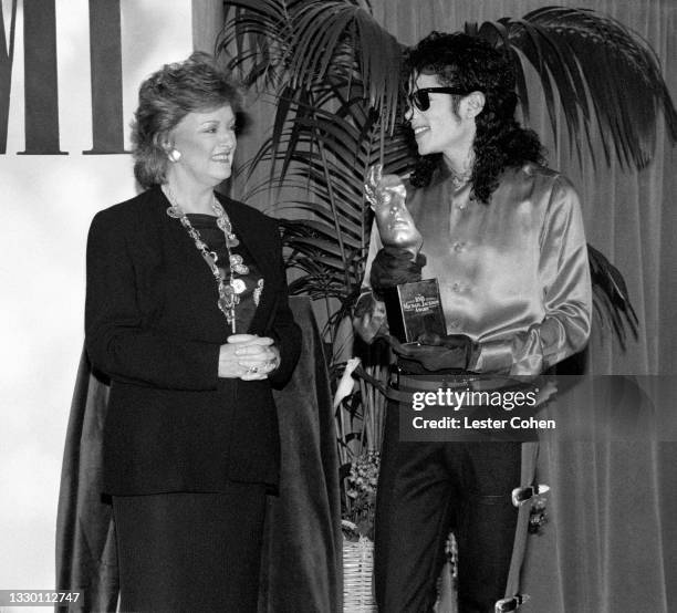 President and CEO Frances W. Preston and American singer, songwriter, and dancer Michael Jackson pose for a portrait on May 8, 1990 at the Beverly...