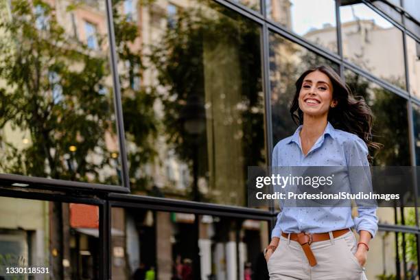 portrait of a young stylish woman walking on the city streets. - motion sickness stock pictures, royalty-free photos & images