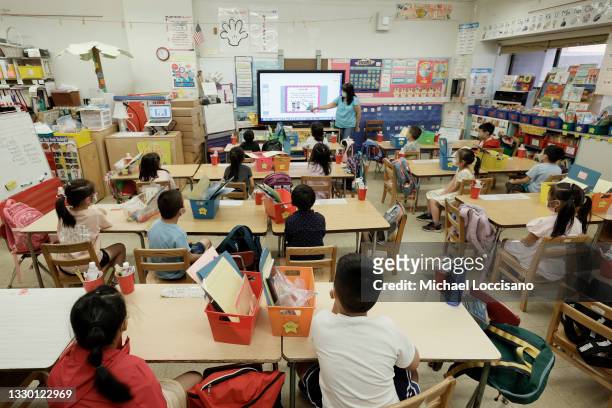 Melissa Moy, a teacher at Yung Wing School P.S. 124, goes over a lesson on a monitor with in-person Summer program students on July 22, 2021 in New...