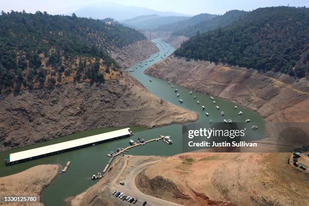 In an aerial view, low water levels are visible at Lime Saddle Marina at Lake Oroville on July 22, 2021 in Paradise, California. As the extreme...