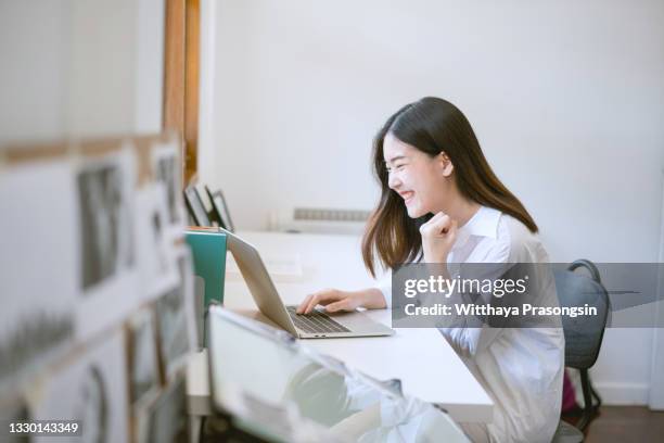 happy ladies and laptops at home - ecstatic asian stock pictures, royalty-free photos & images