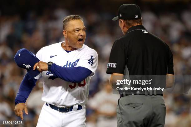 Manager Dave Roberts of the Los Angeles Dodgers reacts after first base umpire Ed Hickox made the call on a no-swing for a walk to Darin Ruf of the...
