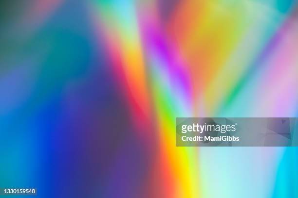 holographic paper reflects rainbow-colored light - rainbow spectrum stock pictures, royalty-free photos & images