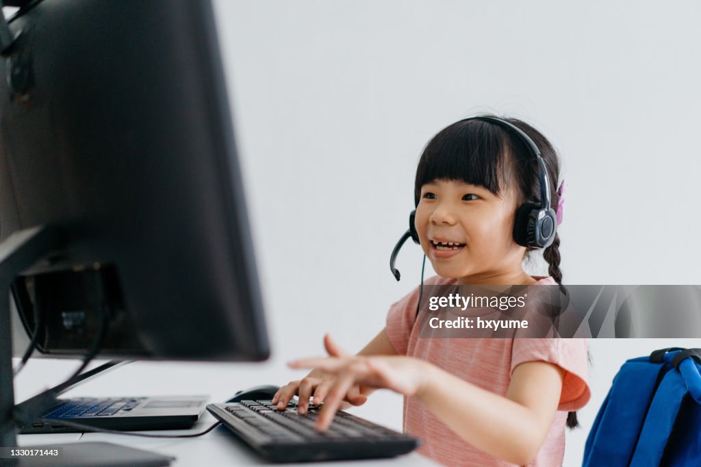 Girl At Computer Young Girl Using Computer And Studying Online At Home High-Res Stock ...