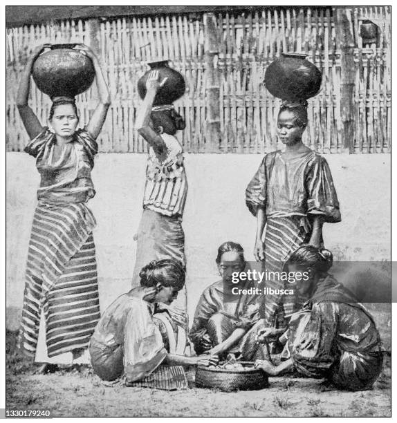 antique black and white photograph: water carriers and fruit vendors, manila, philippines - old manila stock illustrations