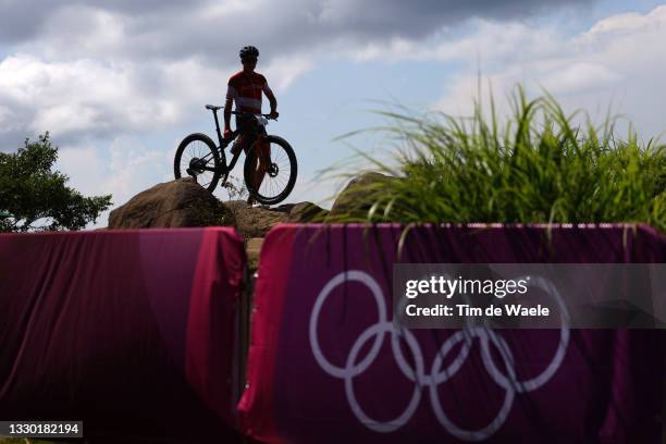 Competitor dismounts their bike during the Mountain bike training session at Izu MTB Course ahead of the Tokyo 2020 Olympic Games on July 23, 2021 in...