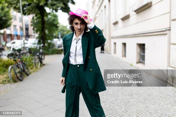attractive non binary person at lgbtq pride parade - german greens party stockfoto's en -beelden