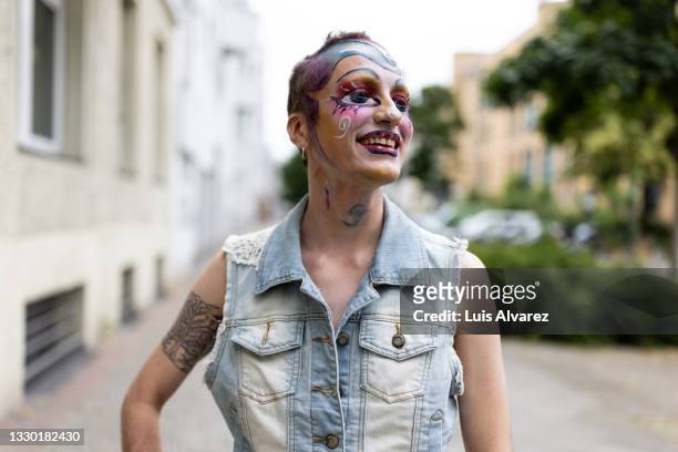 smiling transgender person wearing colorful and attractive makeup - berlin gay pride stock pictures, royalty-free photos & images