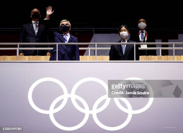 Thomas Bach, IOC President waves as Emperor Naruhito, President of the Tokyo Olympic and Paralympic Games looks on during the Opening Ceremony of the...