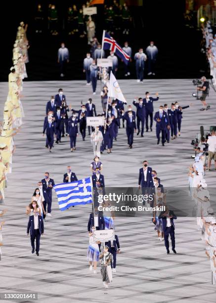 Flag bearer Anna Korakaki of Team Greece leads her team out during the Opening Ceremony of the Tokyo 2020 Olympic Games at Olympic Stadium on July...