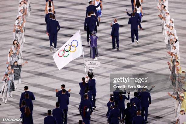 Flag bearers Yusra Mardini and Tachlowini Gabriyesos of the Refugee Olympic Team lead their team out during the Opening Ceremony of the Tokyo 2020...