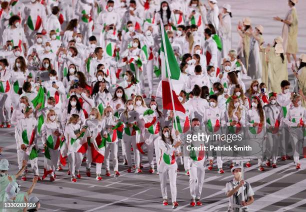 Flag bearers Jessica Rossi and Elia Viviani of Team Italy lead their team in during the Opening Ceremony of the Tokyo 2020 Olympic Games at Olympic...