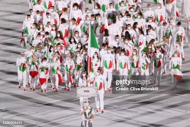 Flag bearers Jessica Rossi and Elia Viviani of Team Italy lead their team out during the Opening Ceremony of the Tokyo 2020 Olympic Games at Olympic...