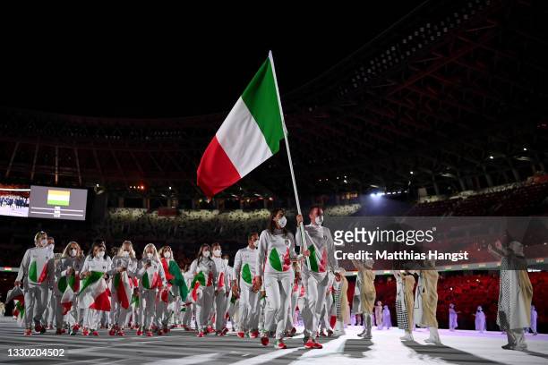 Flag bearers Jessica Rossi and Elia Viviani of Team Italy lead their team out during the Opening Ceremony of the Tokyo 2020 Olympic Games at Olympic...
