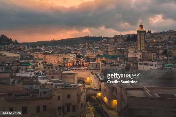 dusk landscape of fez, morocco showing the city and building. - fez marruecos fotografías e imágenes de stock