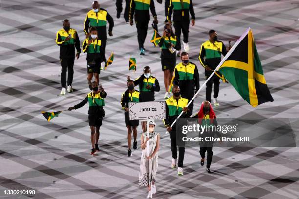 Flag bearers Shelly-Ann Fraser-Pryce and Ricardo Brown of Team Jamaica leads their team in during the Opening Ceremony of the Tokyo 2020 Olympic...