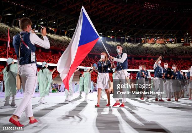 Flag bearers Petra Kvitova and Tomas Satoransky of Team Czech Republic lead their team out during the Opening Ceremony of the Tokyo 2020 Olympic...