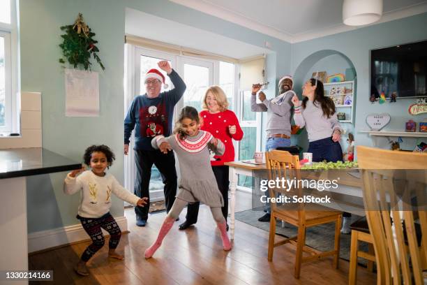 everybody dancing over christmas - christmas fun stock pictures, royalty-free photos & images