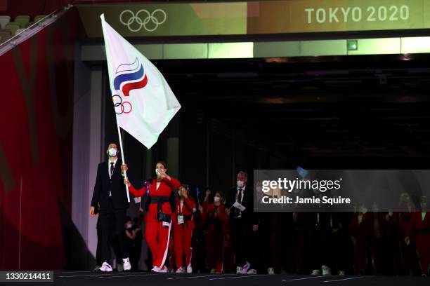 Flag bearers Sofya Velikaya and Maxim Mikhaylov of Team ROC lead their team out during the Opening Ceremony of the Tokyo 2020 Olympic Games at...