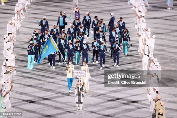 Flag bearers Olga Rypakova and Kamshybek Kunkabayev of Team Kazakhstan during the Opening Ceremony of the Tokyo 2020 Olympic Games at Olympic Stadium...