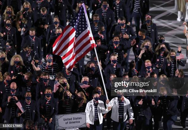 Flag bearers Sue Bird and Eddy Alvarez of Team United States lead their team out during the Opening Ceremony of the Tokyo 2020 Olympic Games at...