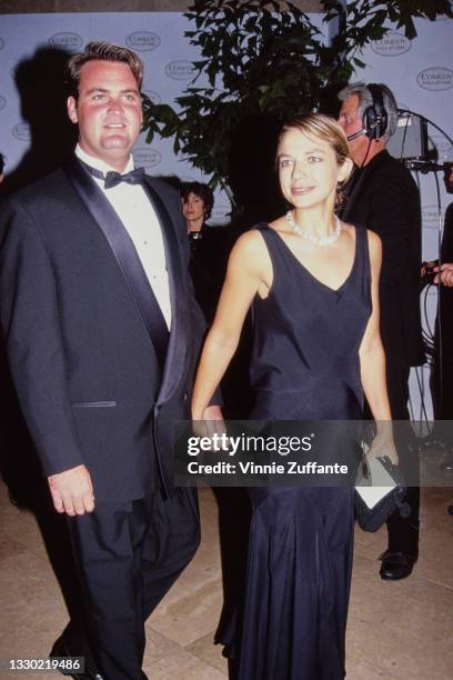 American actress Justine Bateman, wearing a black dress, holding hands with an unspecified guest wearing a tuxedo, at the recording of NBC television...