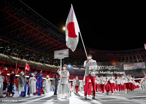 Flag bearers Yui Susaki and Rui Hachimura of Team Japan lead their team out during the Opening Ceremony of the Tokyo 2020 Olympic Games at Olympic...