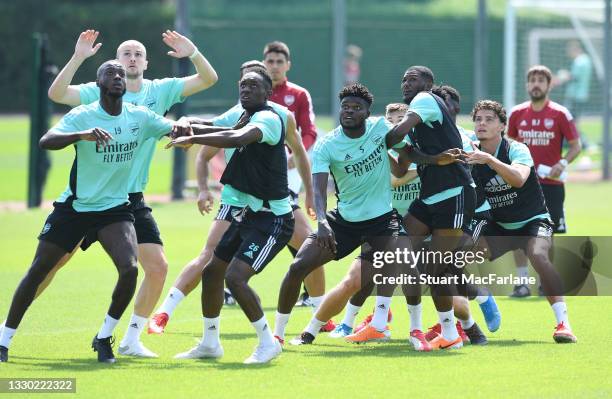 Nicolas Pepe, Ron Holding, Flo Balogun, Thomas Partey, Ainsley Maitland-Niles and Omar Rekik of Arsenal during a training session at London Colney on...