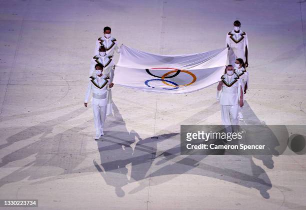 The Olympic flag is carried into the stadium during the Opening Ceremony of the Tokyo 2020 Olympic Games at Olympic Stadium on July 23, 2021 in...
